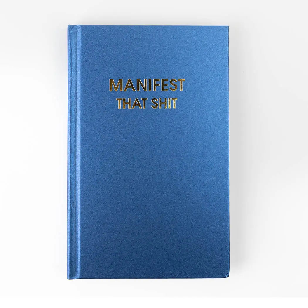 a journal that makes someone laugh. A hard cover journal in royal blue with gold foil print "manifest that shit"