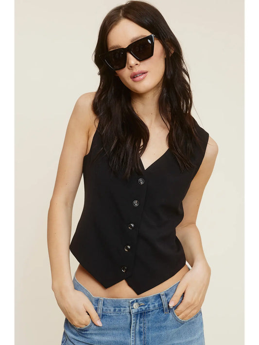 Black button up vest with sunglasses is on trend.