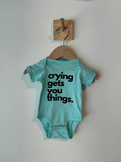 crying gets you things baby onesie