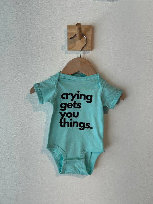 crying gets you things baby onesie