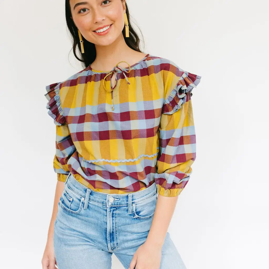Plaid blouse with small ruffles at the shoulder featuring maroon, light blue, and yellow plaid pattern. Perfect for your fall photos and thanksgiving events.