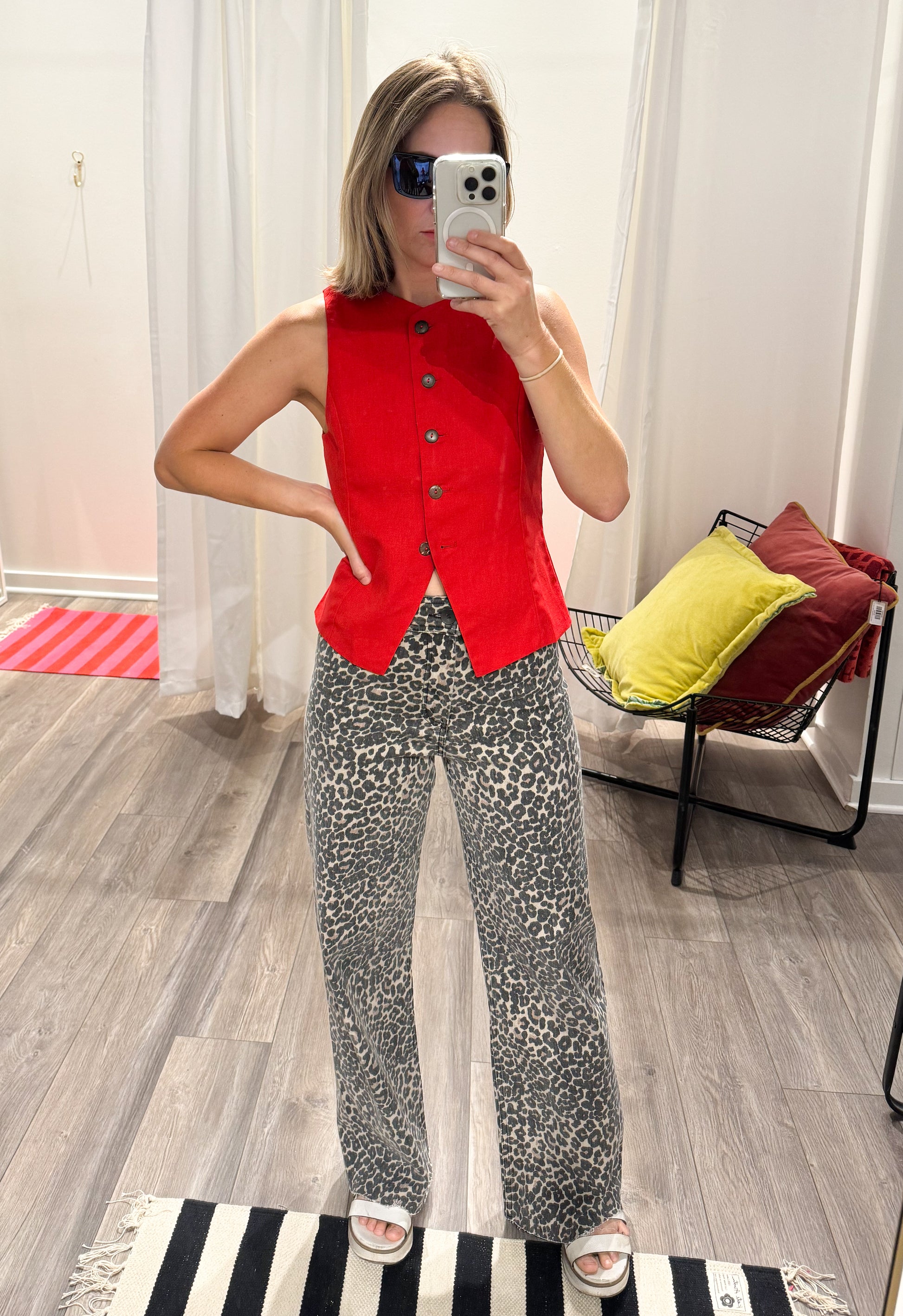 Red sleeveless button up vest with leopard high waisted paints