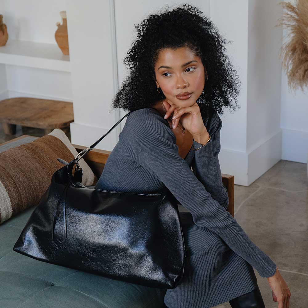 Spacious oversized leather shoulder bag in rich brown, featuring a smooth texture, sturdy straps, and a stylish, minimalist design perfect for everyday use.