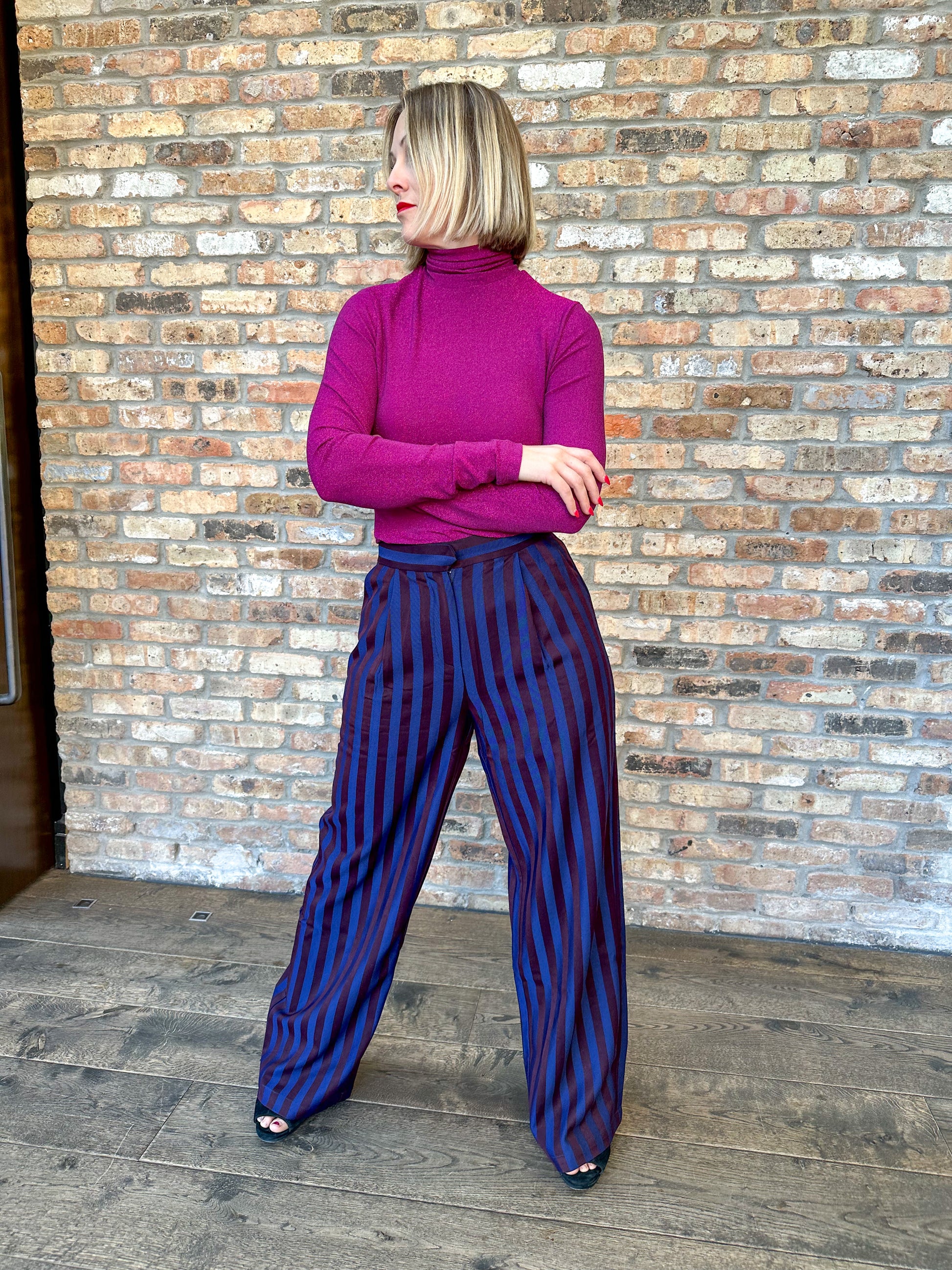 High waisted navy and dark burgundy striped pleated trousers by Frnch. Perfect for holiday parties and events.