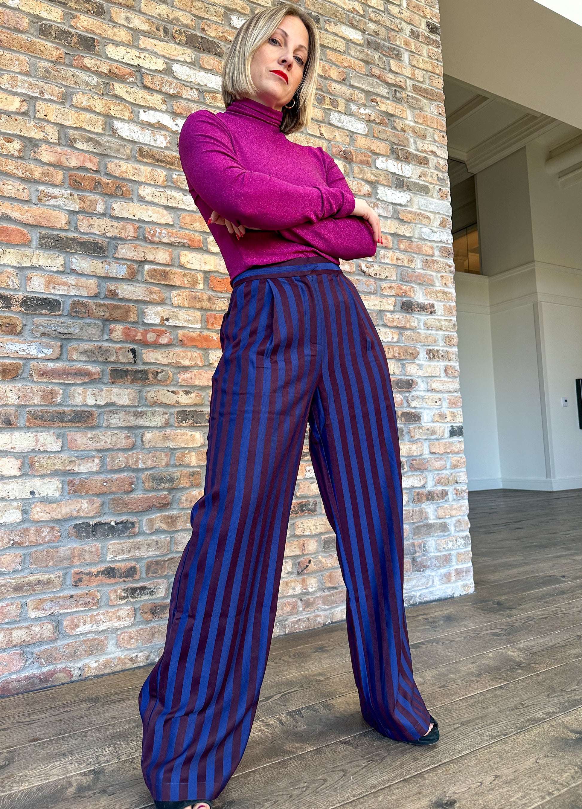 High waisted navy and dark burgundy striped pleated trousers by Frnch. Perfect for holiday parties and events.