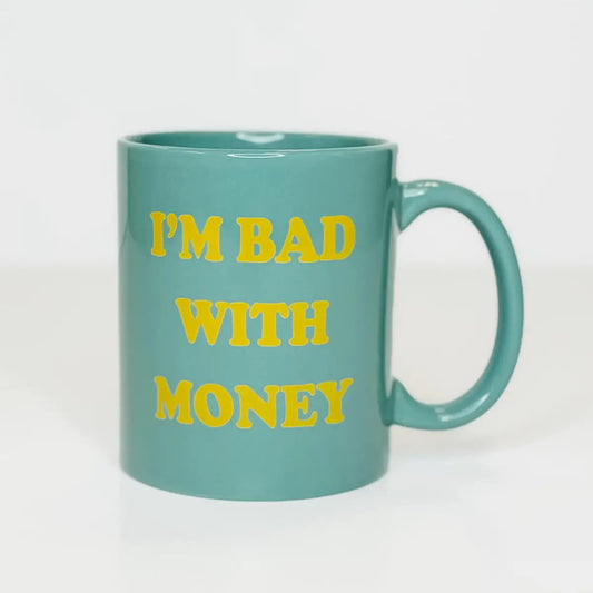 Teal blue coffee mug with bright yellow writing "i'm bad with money" 