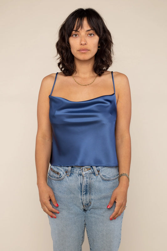 Satin tank blouse in dark navy with adjustable straps and cowl neck, and loose fitting throughout. Spaghetti straps and hitting right at the belly button for an elegant night out outfit.