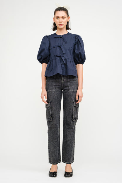 Dark navy blouse with three ties in the front and a slight puff short sleeve. 