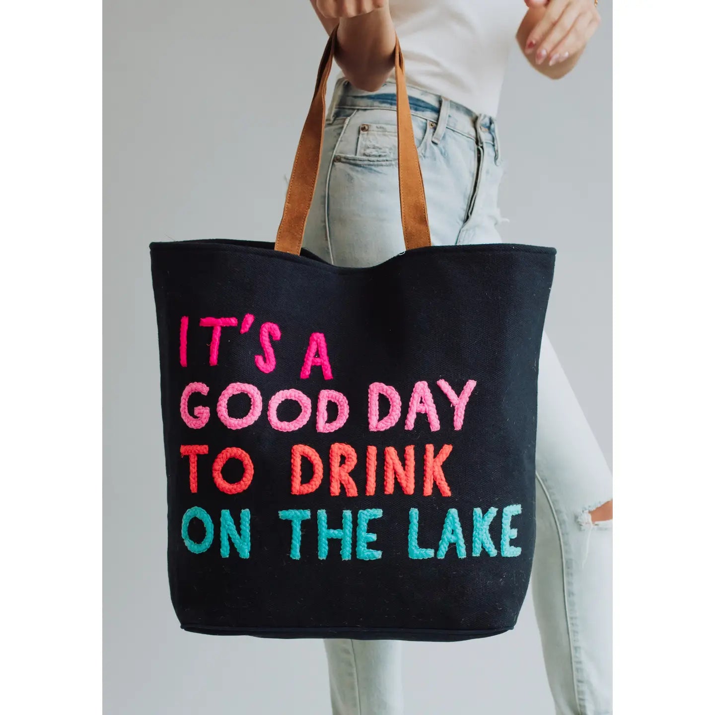 Extra large navy tote with colorful embroidered words "It's a good day to drink on the lake" included with magnetic zipper, double shoulder handle and interior pockets.
