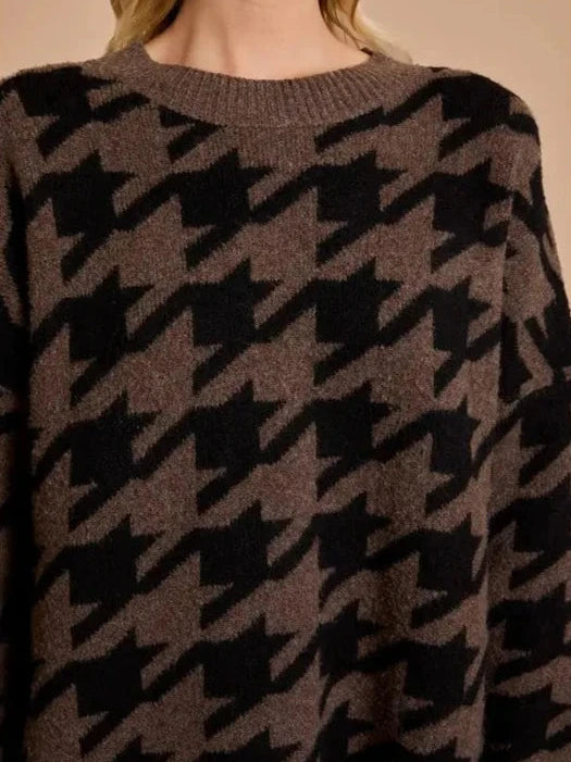 Cozy knit sweater dress in brown and black houndstooth pattern, featuring a relaxed fit, long sleeves, and a super soft texture perfect for autumn outings.