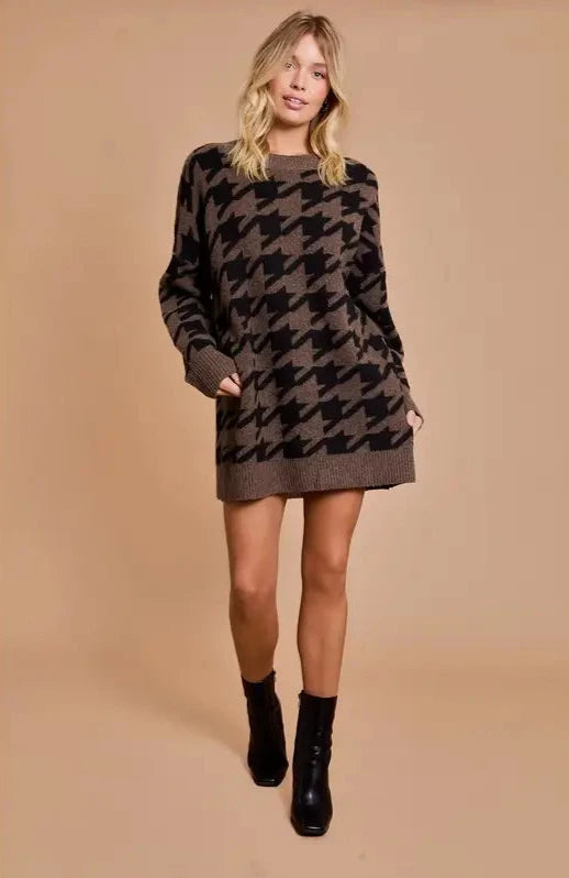 Cozy knit sweater dress in brown and black houndstooth pattern, featuring a relaxed fit, long sleeves, and a super soft texture perfect for autumn outings.