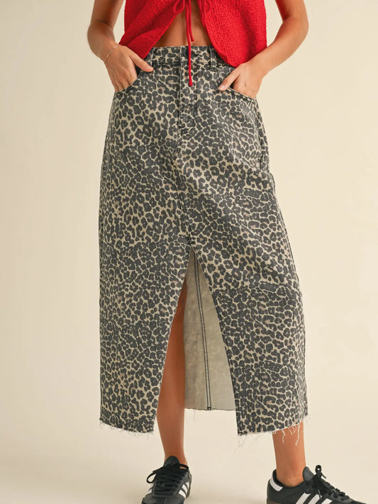 leopard print midi skirt featuring front center slit, button closure and high waisted. Pair with sneakers and tee for a casual look.