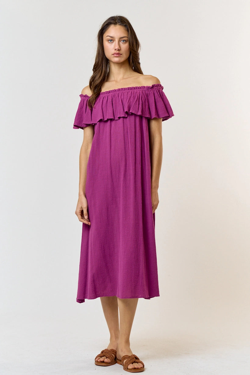 The beautiful 100% cotton magenta midi dress features elastic neckline that can be pushed off the shoulder with ruffle detail at the top and a free and flowy straight cut to the mid length. A vacation cover up dress or summer pool day. 