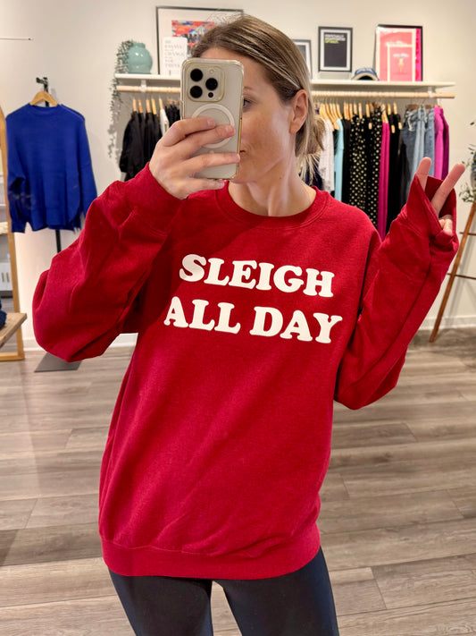 Holiday red unisex sweatshirt with white bold lettering "sleigh all day"