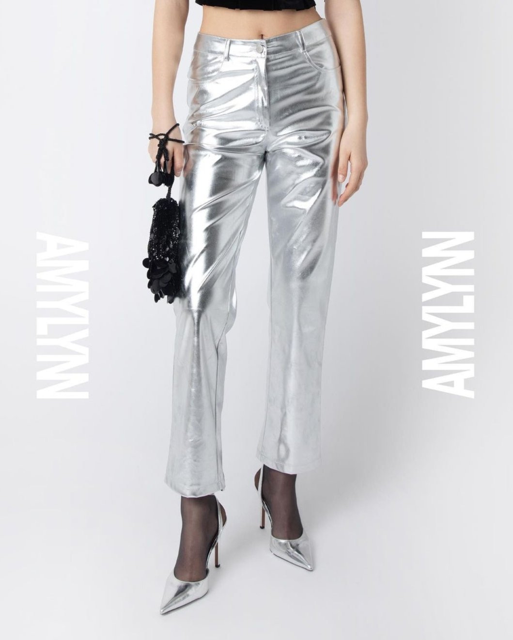 Metallic silver high waisted trousers with straight leg. Featuring front pockets, belt loops and button closure. Perfect for your next holiday party or event.