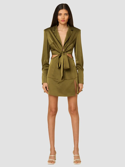 Olive heavy satin mini dress featuring cut out waist design, front button and tie closure and shoulder pads, perfect for a sexy night out.